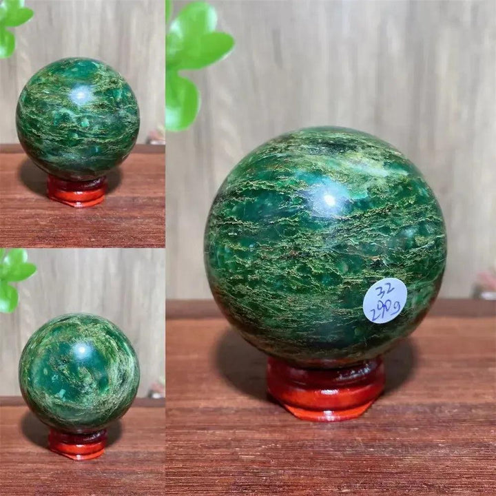 Polished Verdite sphere with deep forest green hues and shimmering gold veins, displayed on a red wooden stand.