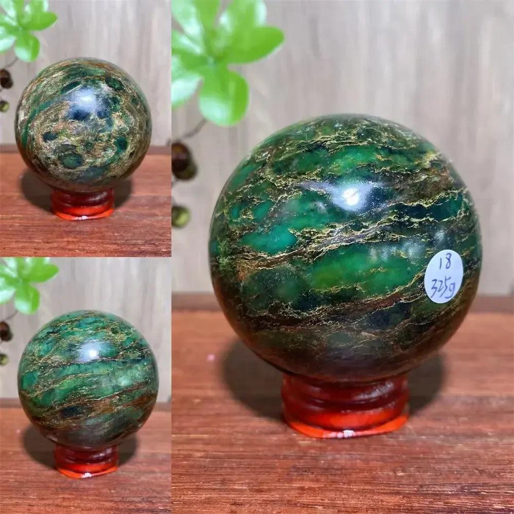Verdite sphere with deep forest green and shimmering gold veins on a red display stand.