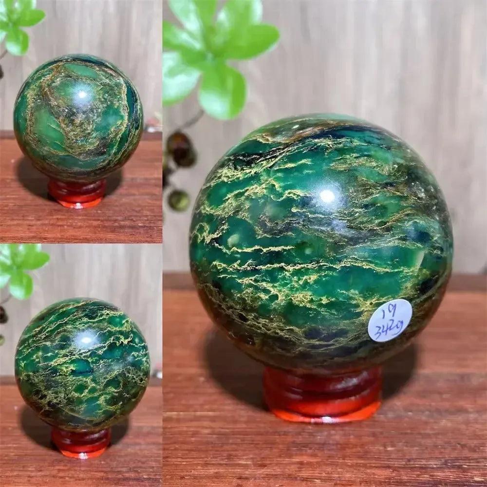 Verdite sphere with deep forest green and shimmering gold veins, displayed on a reddish-brown stand.