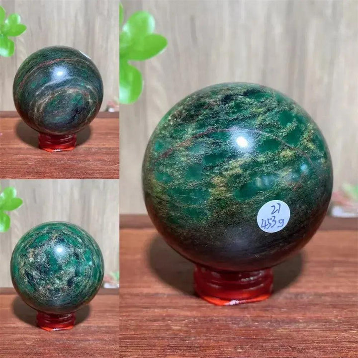 Polished Verdite sphere with deep forest green and shimmering gold veins on a red stand.
