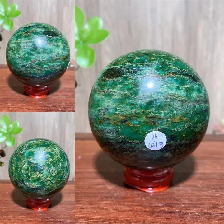Verdite sphere with deep forest green hues and shimmering gold veins on a red display stand.