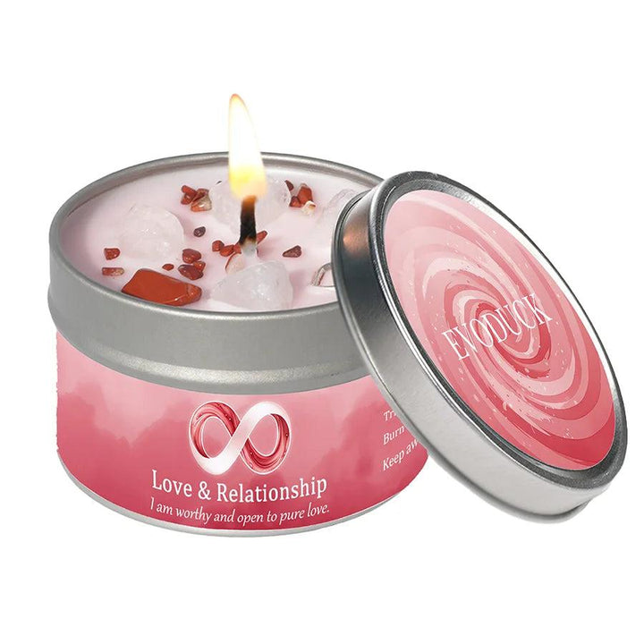 Vetiver Cedarwood "Love & Relationship" intention candle tin with clear quartz & red jasper, burning brightly.