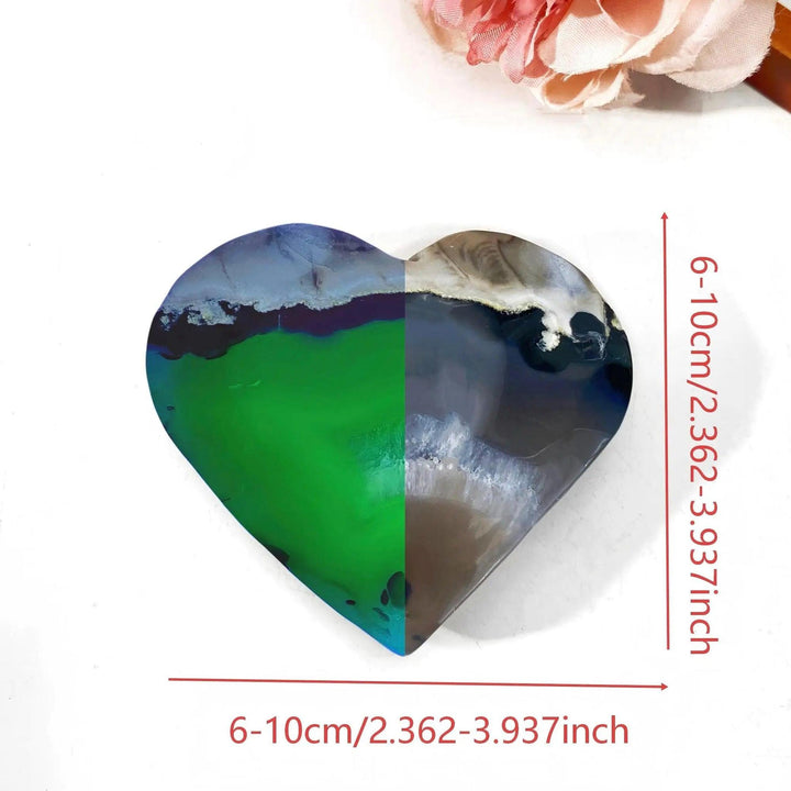 Heart-shaped volcanic agate stone, half vibrant green, half natural grey-blue, with UV fluorescent properties.