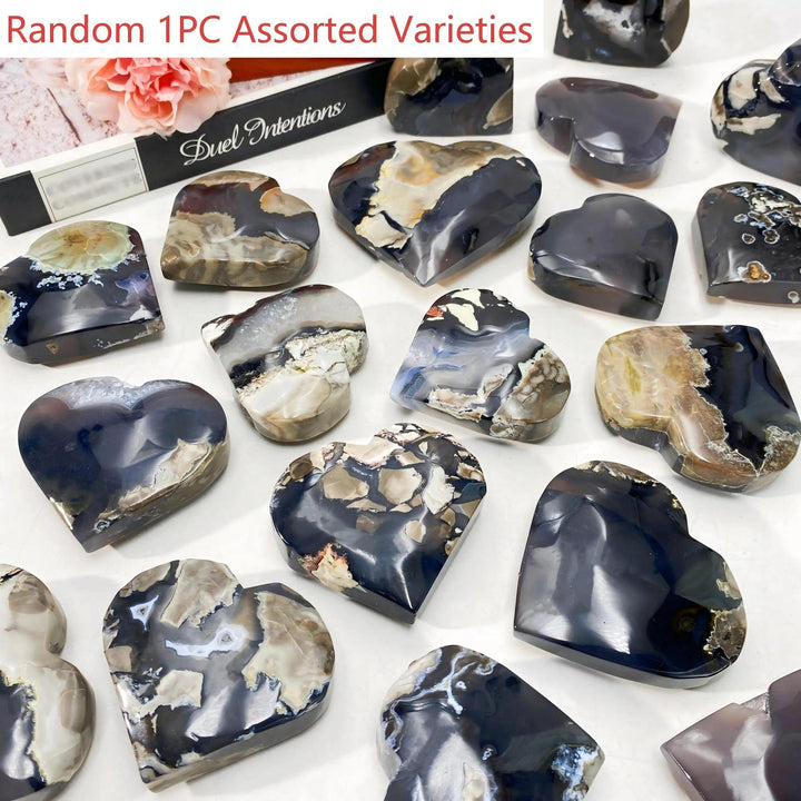 Assorted volcanic agate heartstones, polished with unique black, white, and brown patterns, ideal for gifts or decor.
