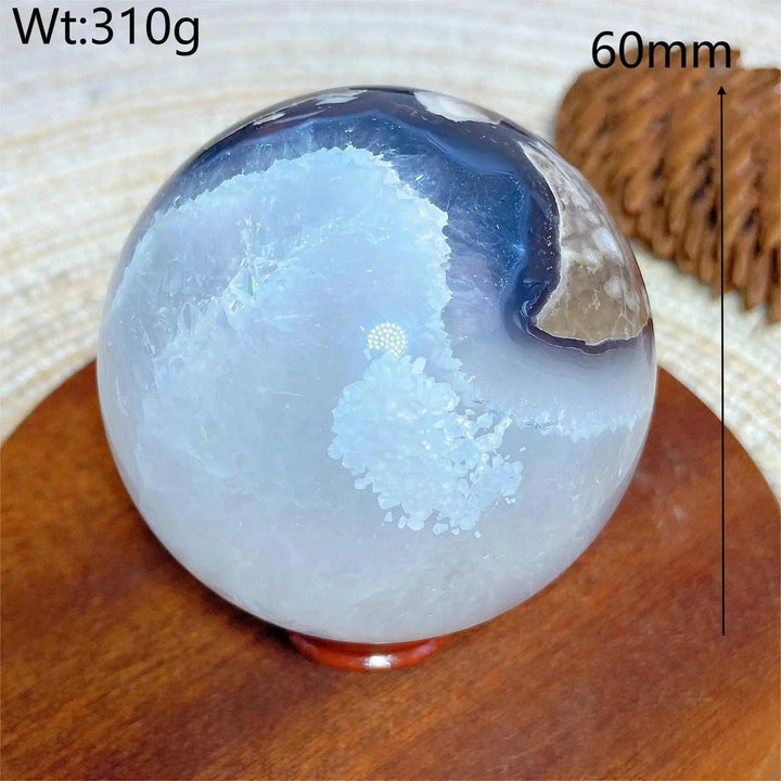 Volcanic Agate Sphere, a 60mm, 310g UV reactive crystal ball with white, blue, and earthy bands.