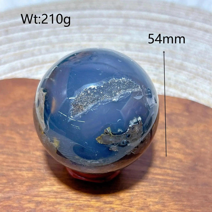 Volcanic Agate Sphere, 54mm, 210g. Deep blue-black with a sparkling druzy cavity, grounding and transformative.