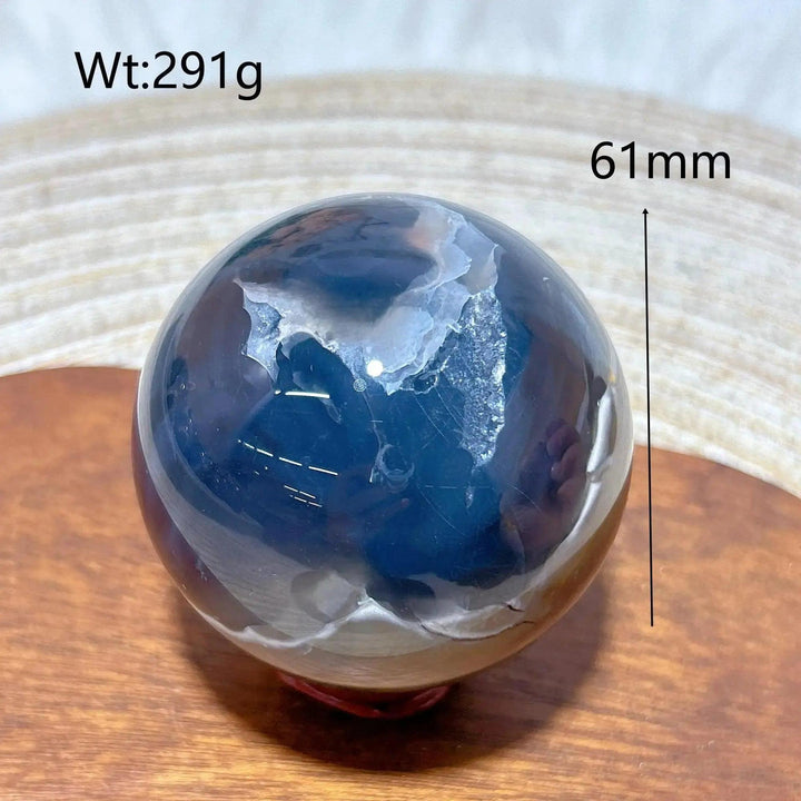 Volcanic Agate Sphere, a 61mm, 291g UV reactive crystal ball with rich banding and hidden fluorescent colors.