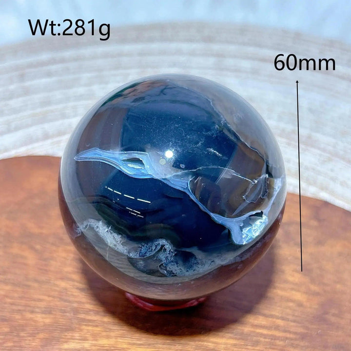 Volcanic Agate Sphere, a 60mm, 281g UV reactive crystal ball with rich banding, grounding and transformative.