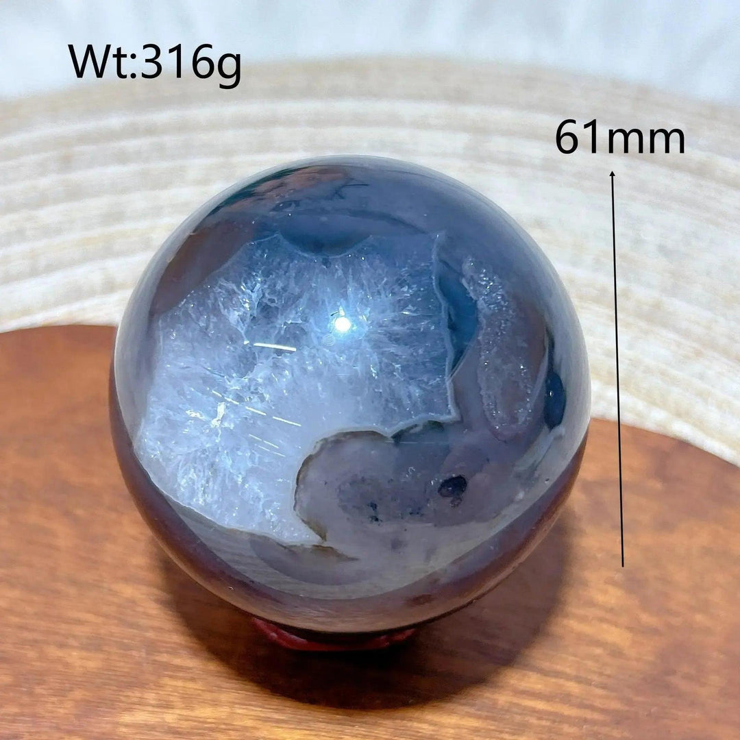 Volcanic Agate Sphere, a 61mm, 316g UV reactive crystal ball with rich banding and hidden fluorescent colors.