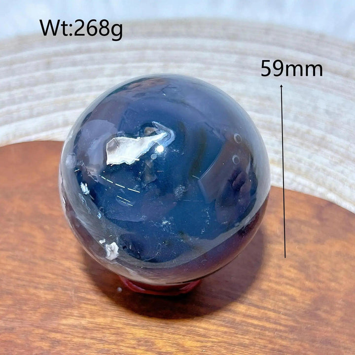 Volcanic Agate Sphere, a 59mm, 268g UV reactive crystal ball with rich, dark banding and a unique geological fingerprint.