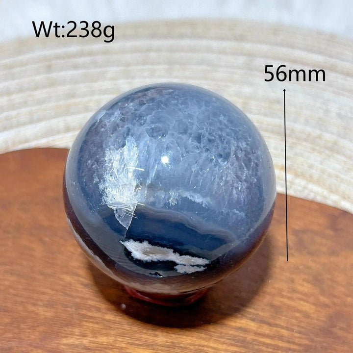 Volcanic Agate Sphere, a 56mm, 238g grounding and transformative crystal ball with earthy bands and UV reactive properties.