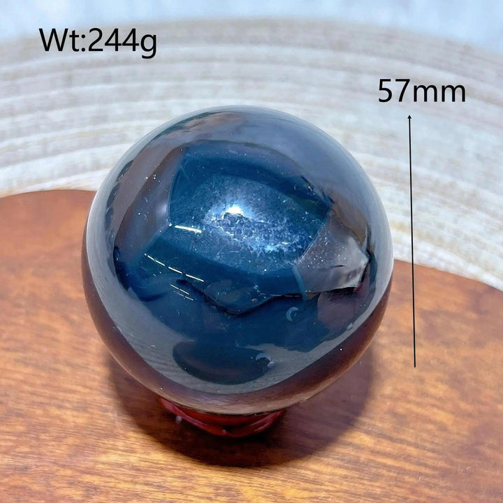Volcanic Agate Sphere, a 244g, 57mm hand-polished, dark, UV reactive crystal ball for grounding and transformation.