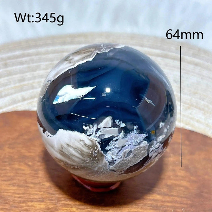 Volcanic Agate Sphere, a 64mm, 345g hand-polished crystal ball with deep blue, white, and earthy bands.