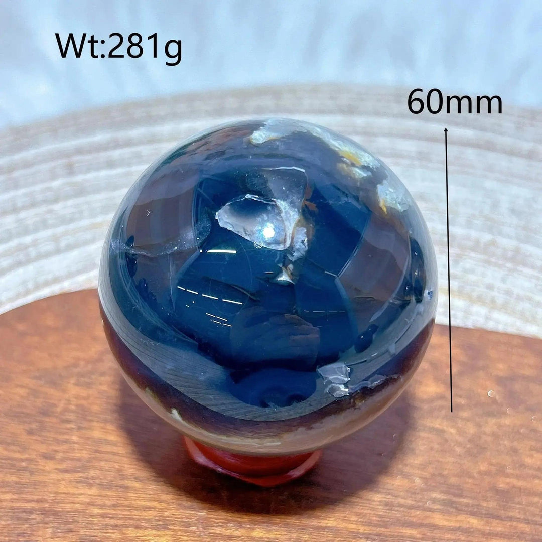 Volcanic Agate Sphere, a 60mm, 281g UV reactive crystal ball with rich, earthy bands and hidden fluorescent colors.