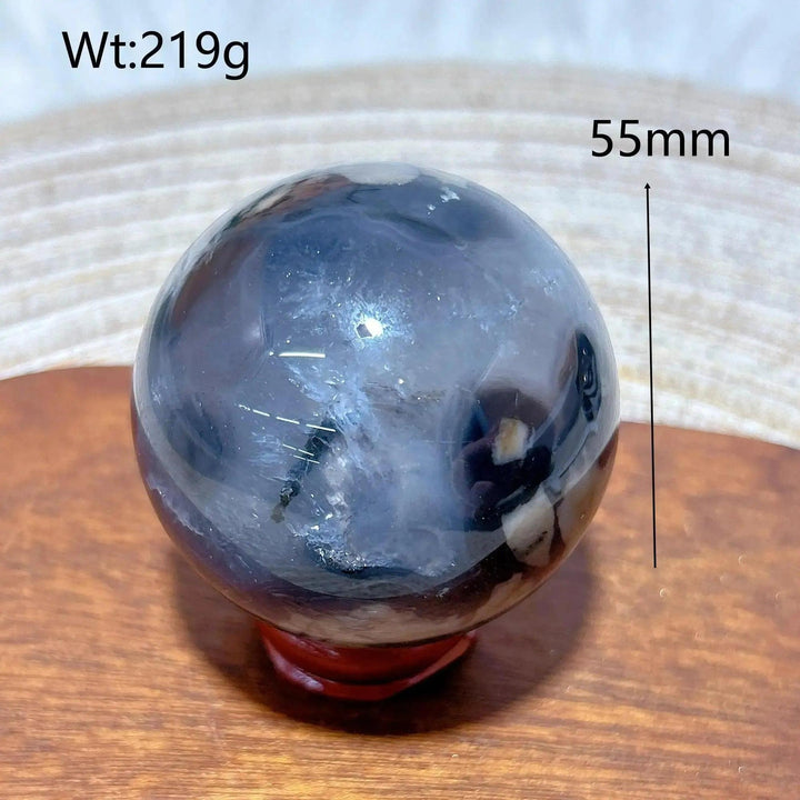 Volcanic Agate Sphere, a 219g, 55mm UV reactive crystal ball with earthy bands and hidden fluorescent colors.