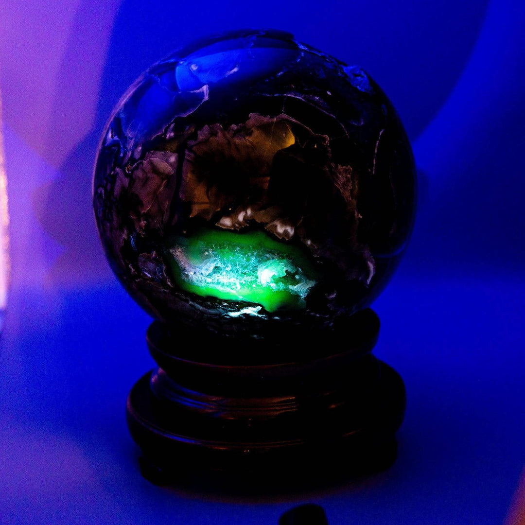 Volcano Agate Sphere XXL, a 47lb UV reactive crystal ball with glowing green and blue volcanic patterns.