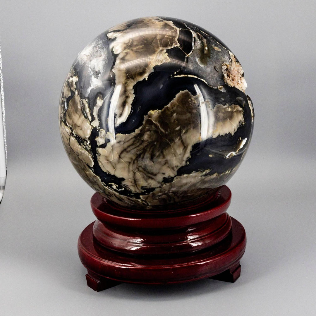 Volcano Agate Sphere XXL: 47lb polished stone with swirling rust, cream, deep brown, and ochre banding on a wood stand.