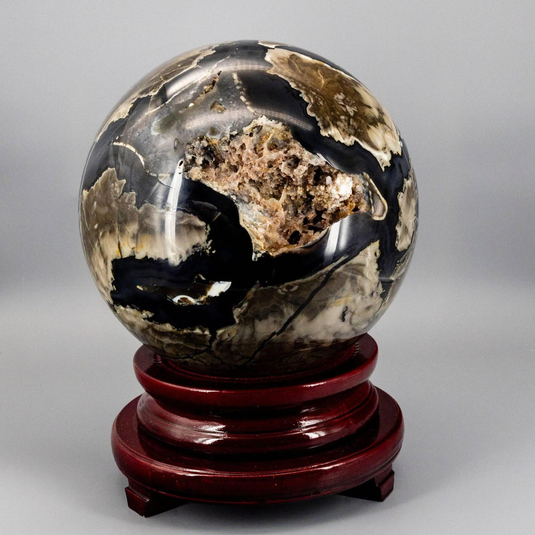 Volcano Agate Sphere XXL: 47lb UV reactive crystal sphere with swirling volcanic banding, earthy tones, and a geode cavity.
