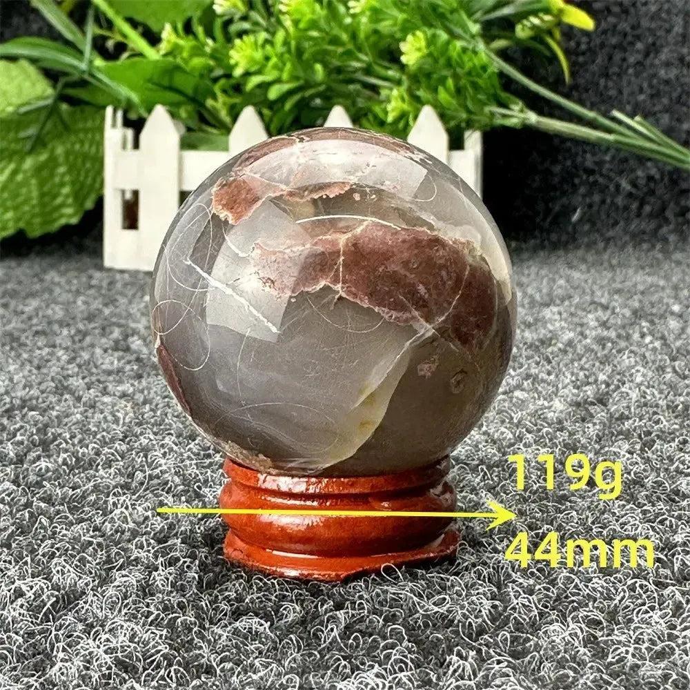 Volcano Agate sphere, 44mm, 119g, with fiery earth tones on a wooden stand from Crystal Destiny.