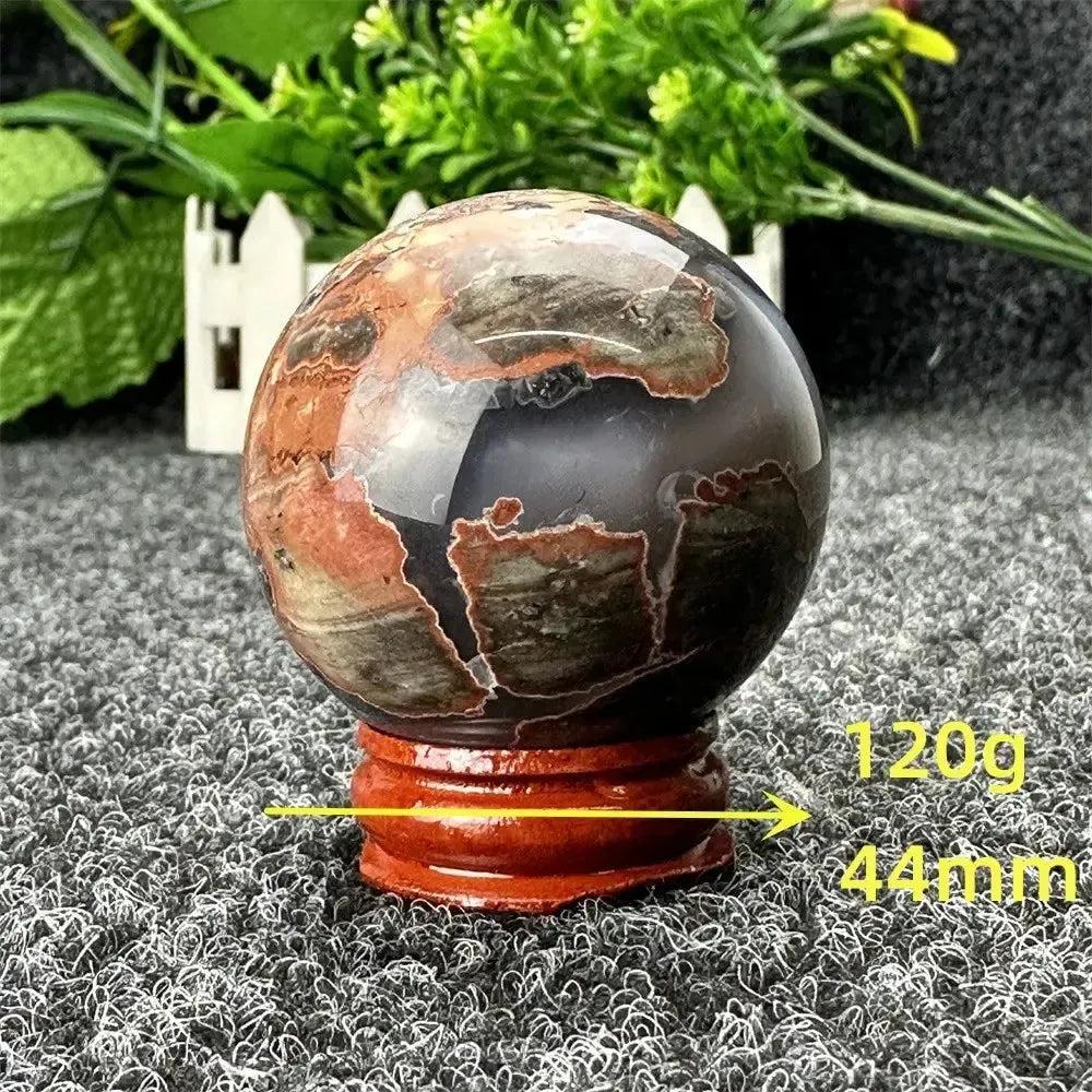 Volcano Agate sphere, 120g, 44mm, with fiery earth tones on a wooden stand from Crystal Destiny.