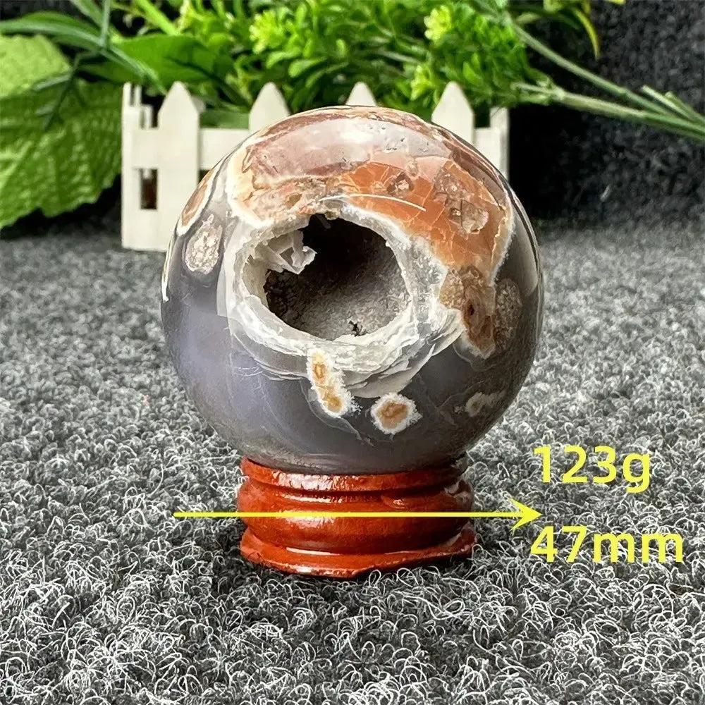 Volcano Agate sphere by Crystal Destiny, 47mm, 123g, with fiery earth tones and a natural geode opening.