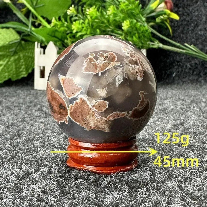 Volcano Agate sphere by Crystal Destiny, 125g, 45mm, with fiery earth tones and intricate banding on a wood stand.