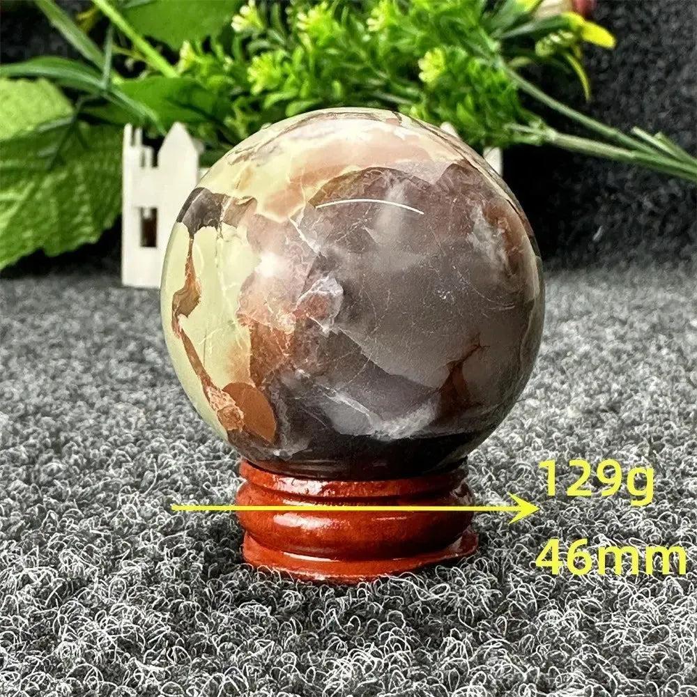 Crystal Destiny's Volcano Agate sphere, 129g, 46mm, with fiery earth tones on a wooden stand.