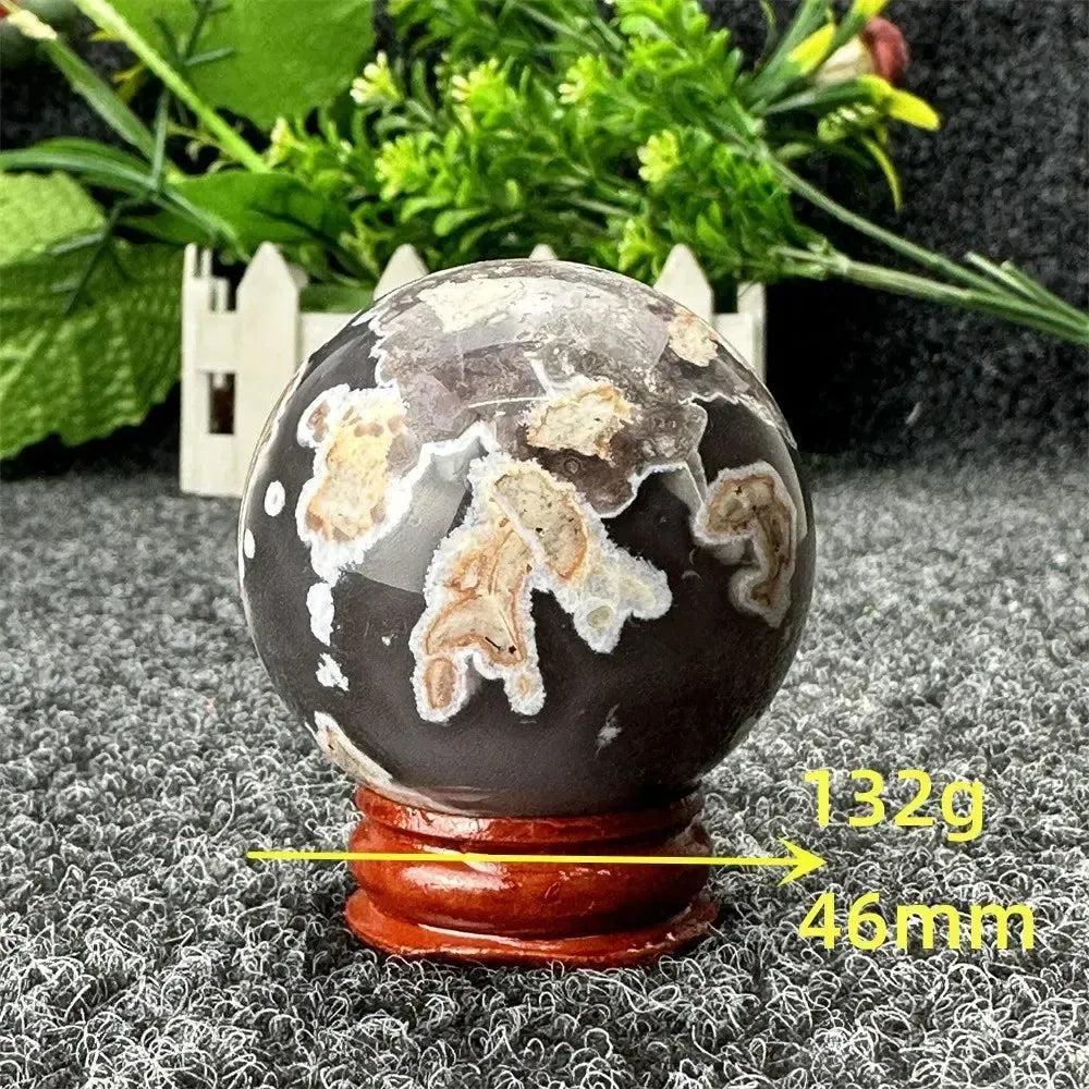 Volcano Agate sphere by Crystal Destiny, featuring fiery earth tones, intricate banding, and a grounding energy.
