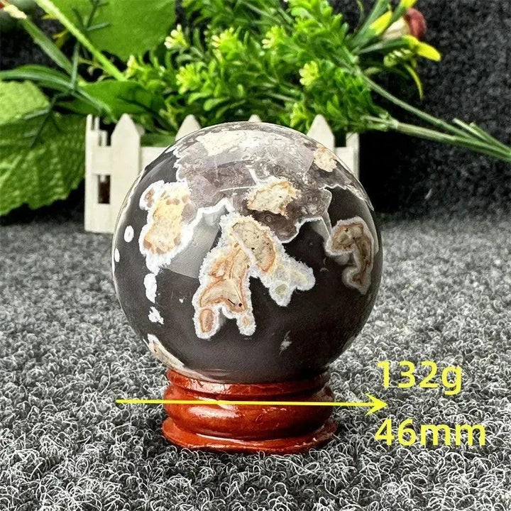 Volcano Agate sphere by Crystal Destiny, featuring fiery earth tones, intricate banding, and a grounding energy.