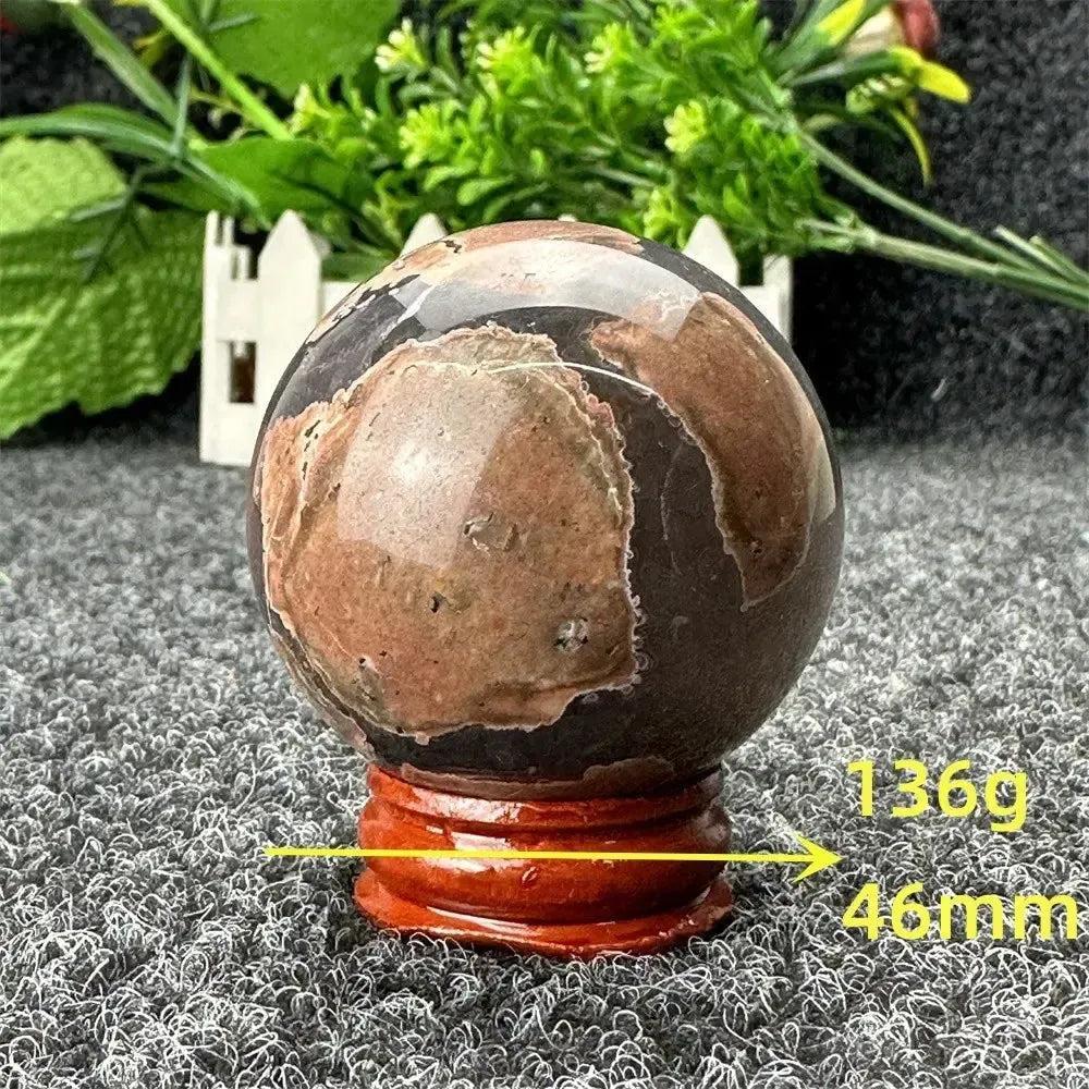 Polished Volcano Agate sphere from Crystal Destiny, 46mm, 136g, with fiery earth tones and dramatic patterns on a wooden stand.