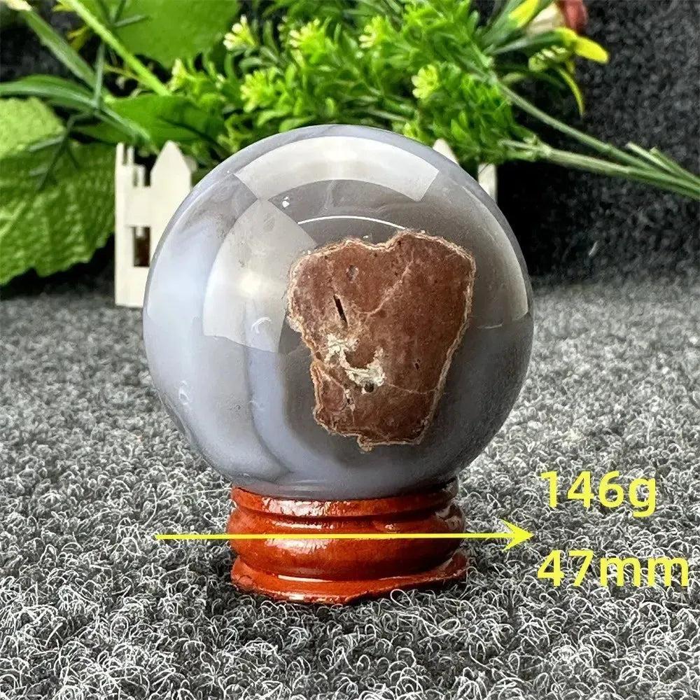 Polished gray and brown Volcano Agate sphere on a wooden stand, 146g, 47mm, from Crystal Destiny.