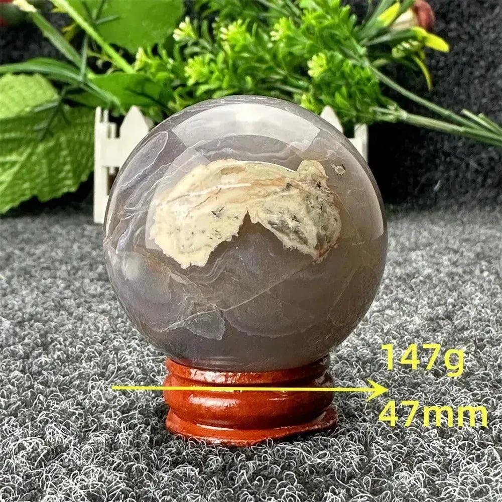 Volcano Agate sphere by Crystal Destiny, 47mm, 147g, with fiery earth tones and unique patterns on a wooden stand.