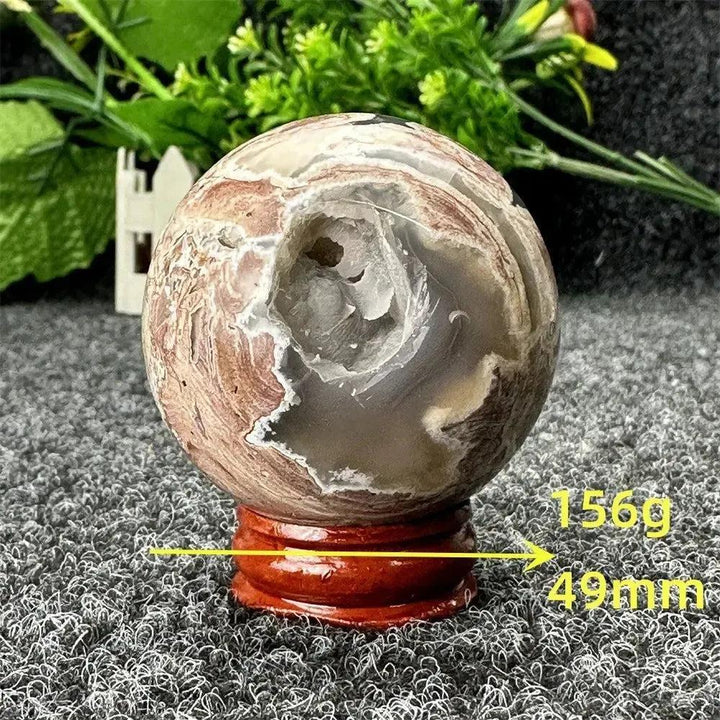Volcano Agate sphere, 156g, 49mm, with fiery earth tones and a geode cavity, from Crystal Destiny.