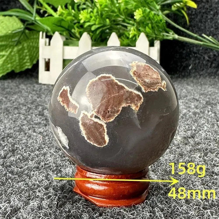 Crystal Destiny Volcano Agate sphere, 158g, 48mm, with fiery earth tones and grounding energy on a wooden stand.