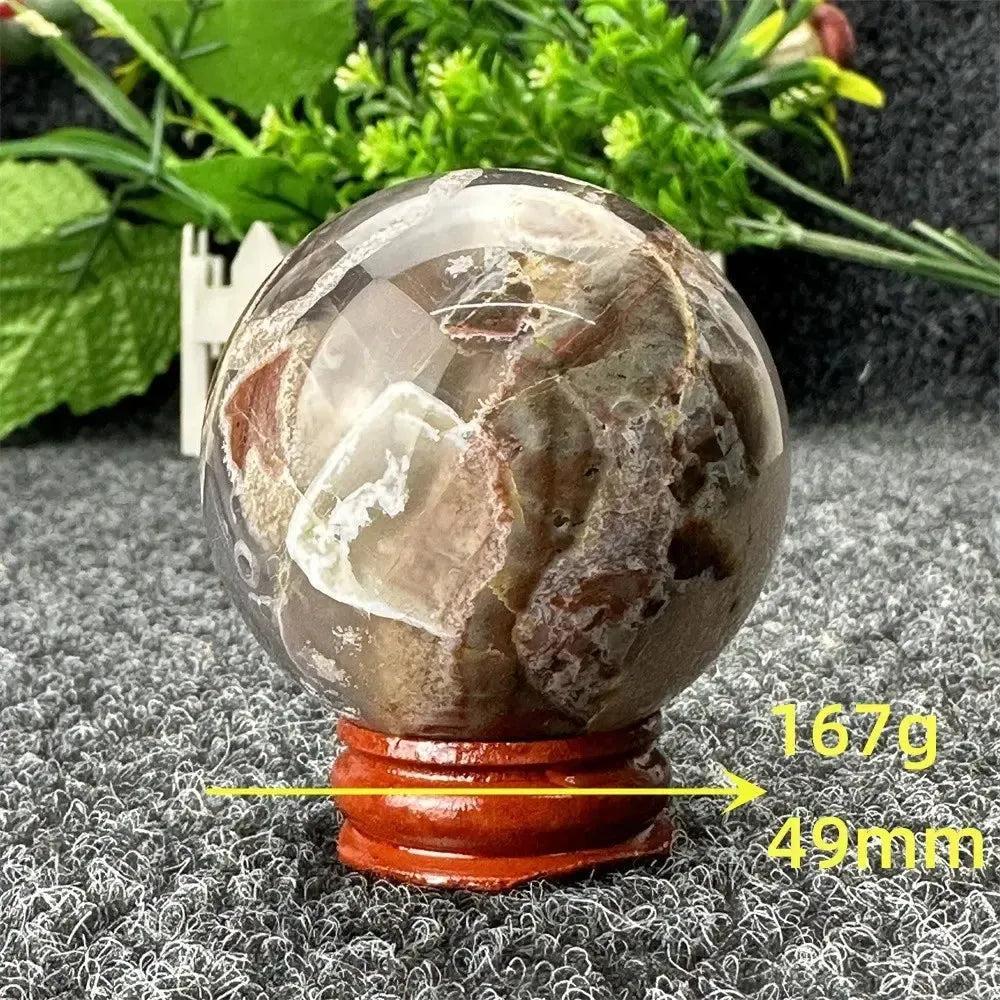 Polished Volcano Agate sphere from Crystal Destiny, displaying fiery browns, reds, and amber, 167g, 49mm.