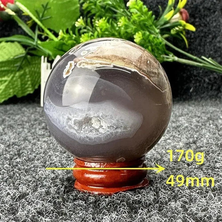 Volcano Agate sphere by Crystal Destiny, 170g, 49mm, with fiery earth tones and white geode banding on a wood stand.