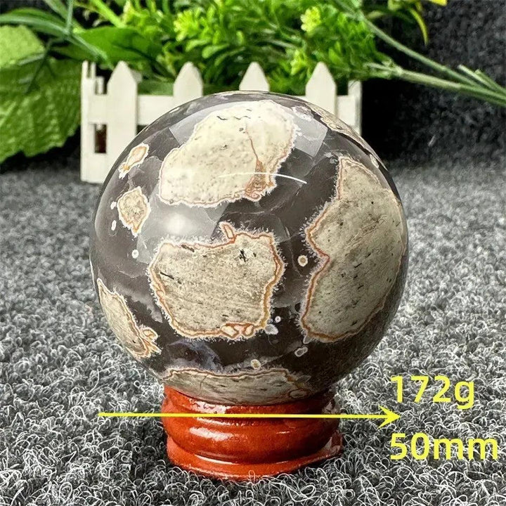 Volcano Agate sphere from Crystal Destiny, featuring dark brown and light grey patterns, 50mm, 172g.
