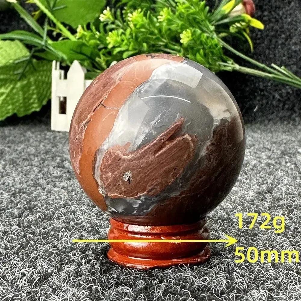 Volcano Agate sphere by Crystal Destiny, 50mm, 172g. Fiery red, brown, and gray patterns on a polished crystal.