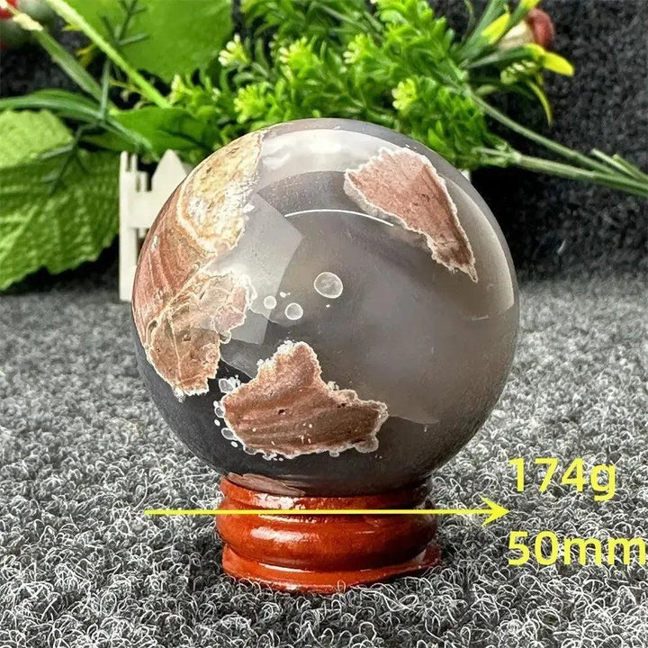 Volcano Agate sphere by Crystal Destiny, 50mm, 174g. Features fiery earth tones, dramatic patterns, and grounding energy.