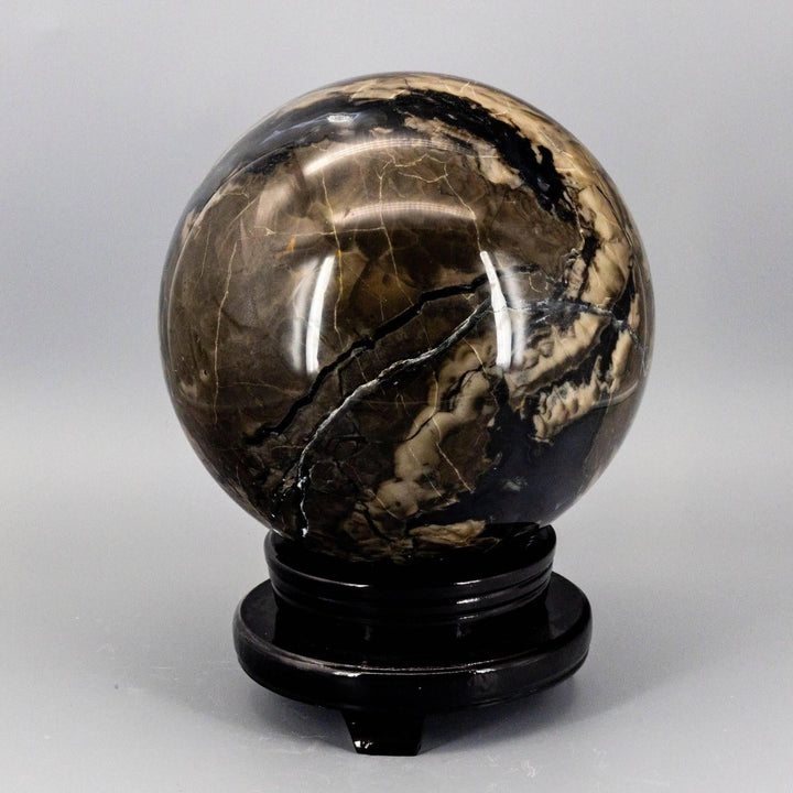 Huge 186mm Volcano Agate Sphere, UV Reactive, with swirling volcanic banding, rust, cream, and deep brown tones.