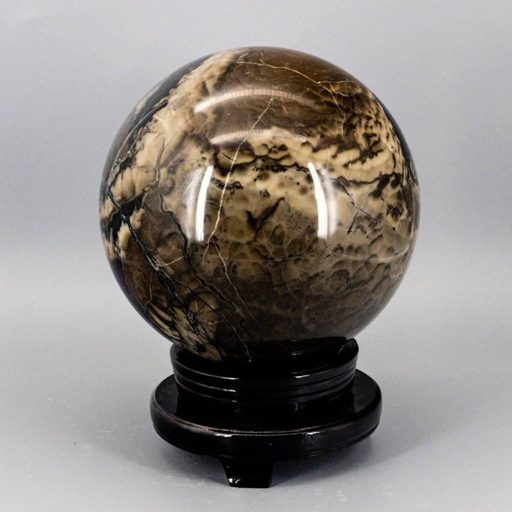 Volcano Agate Sphere, 186mm, with swirling volcanic banding in rust, cream, and deep brown, on a dark stand.