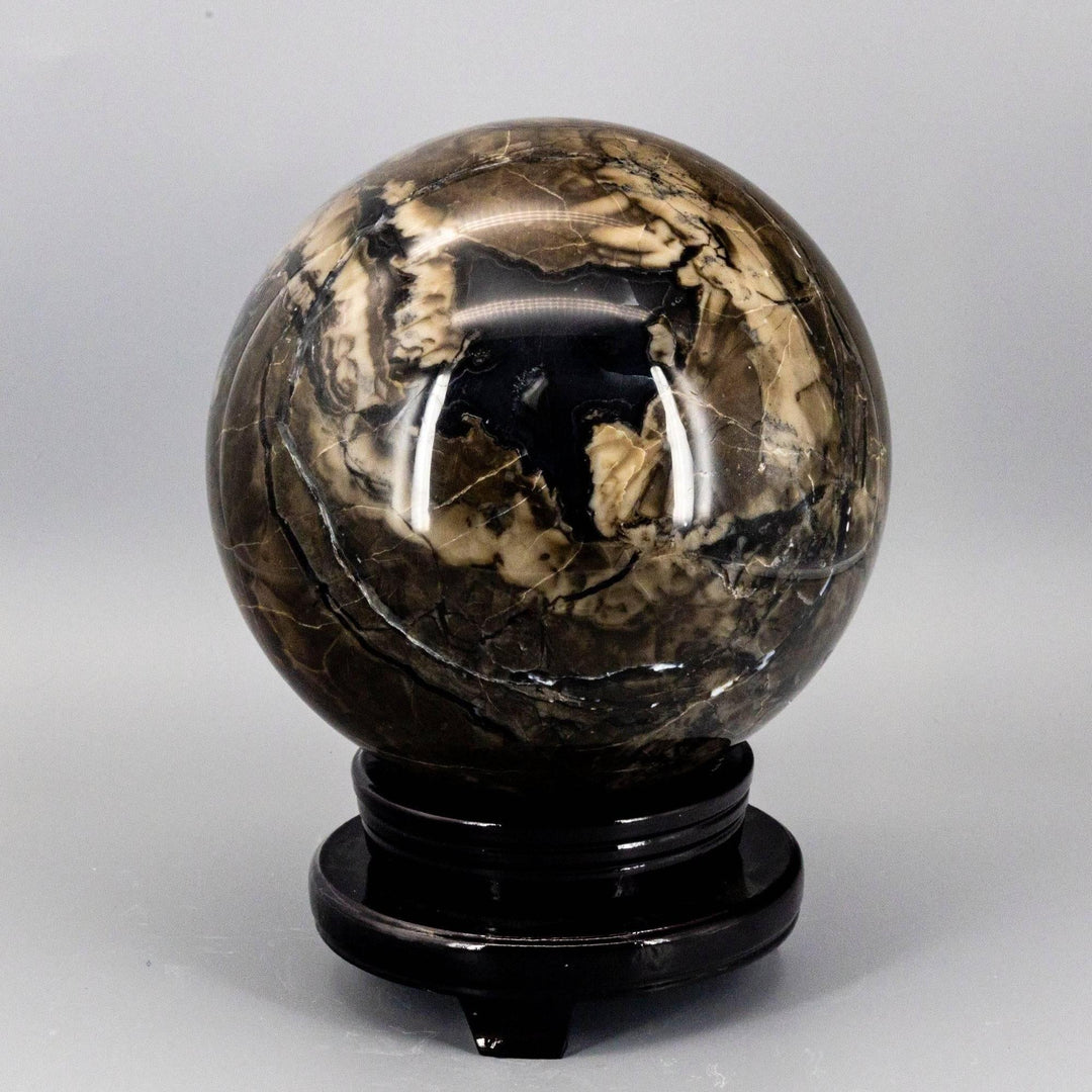 Volcano Agate Sphere, 186mm, UV Reactive, with swirling volcanic banding in rust, cream, and deep brown.