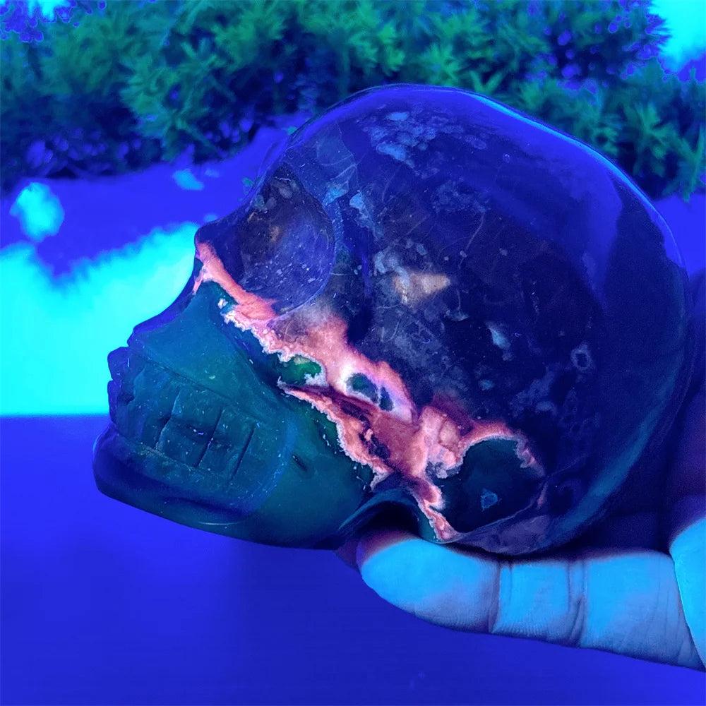 Hand-carved Volcano Agate and Calcite crystal skull with vibrant glowing accents for Reiki healing and home decor.