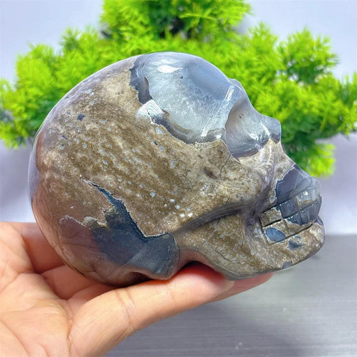Hand-carved Volcano Agate and Calcite crystal skull, featuring earthy tones and healing energy for unique home decor.