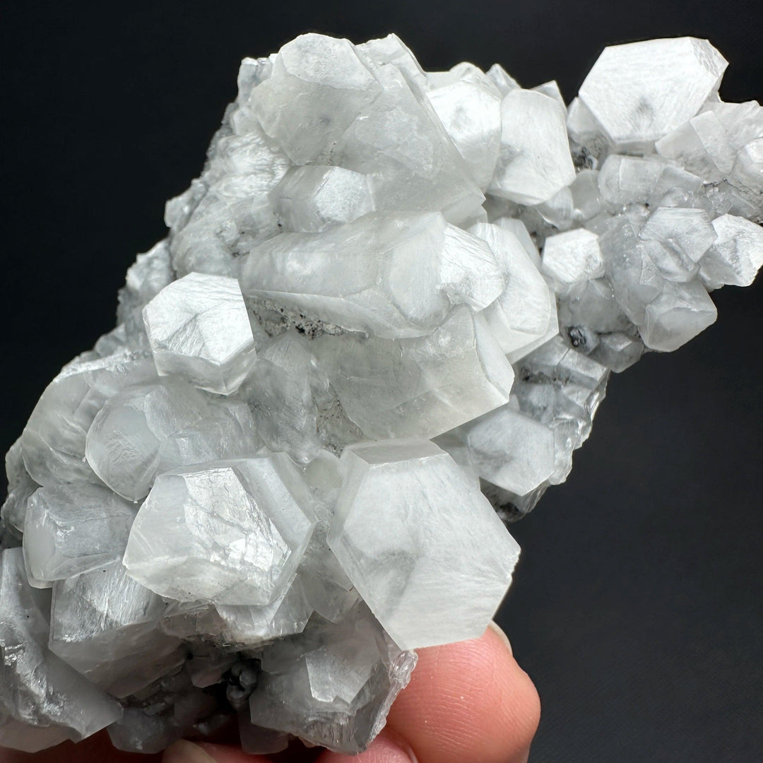 Raw white calcite crystal cluster healing stone specimen with shimmering hexagonal points.