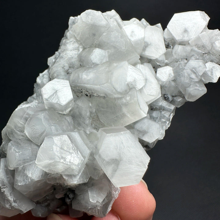Raw white calcite crystal cluster healing stone specimen with shimmering hexagonal points.