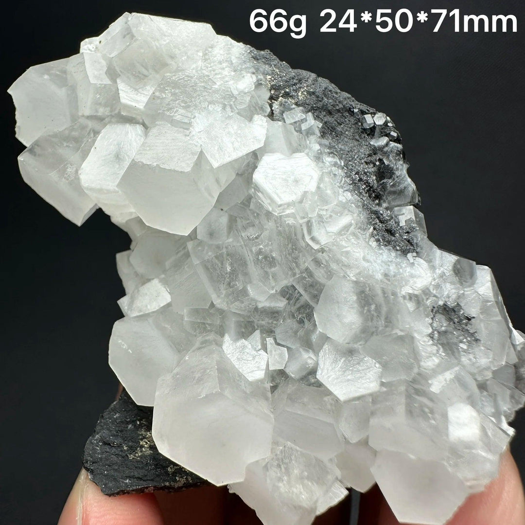 Raw white calcite crystal cluster specimen with cubic formations on dark matrix for healing and home decor.