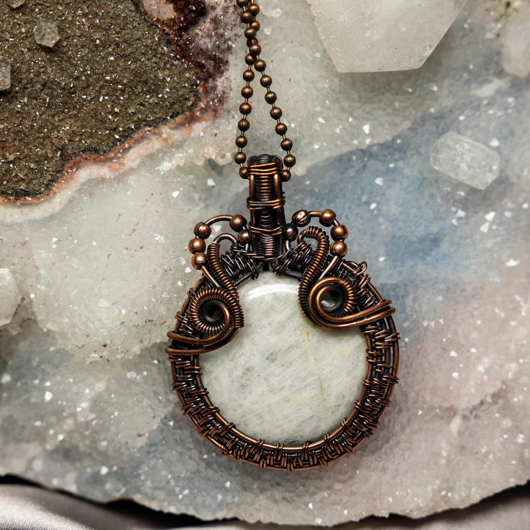 Handcrafted White Quartz Wire Wrap Crystal Pendant with healing copper, radiating clarity and spiritual openness.