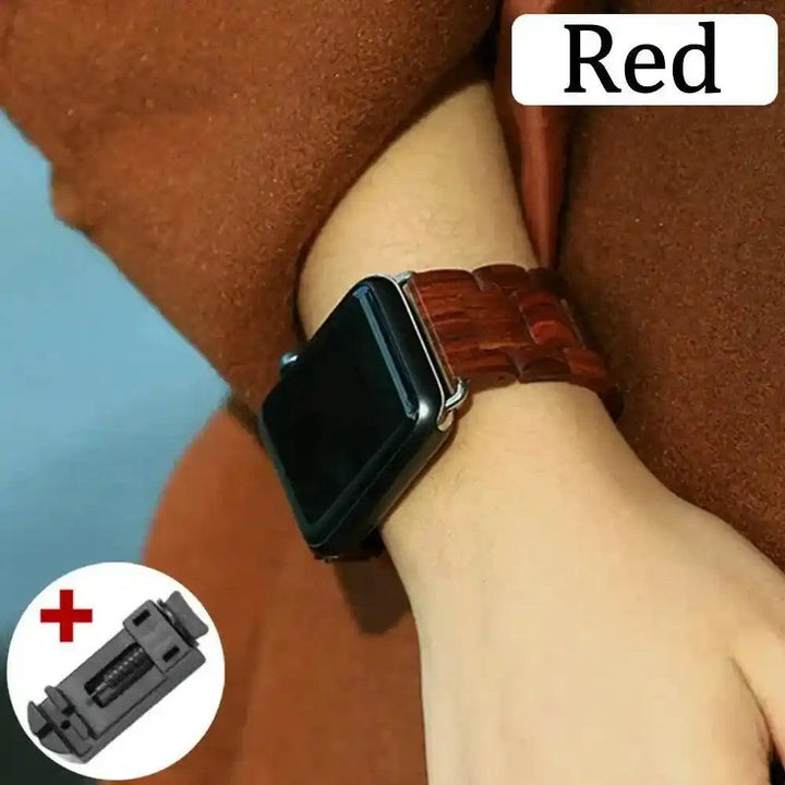 Red handcrafted wooden Apple Watch band with distinctive grains on a wrist, plus a band adjustment tool.