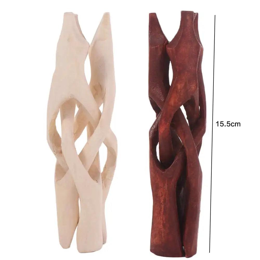 Two 15.5cm tall carved wooden tripod stands, one light natural wood and one dark reddish-brown, for crystal spheres.
